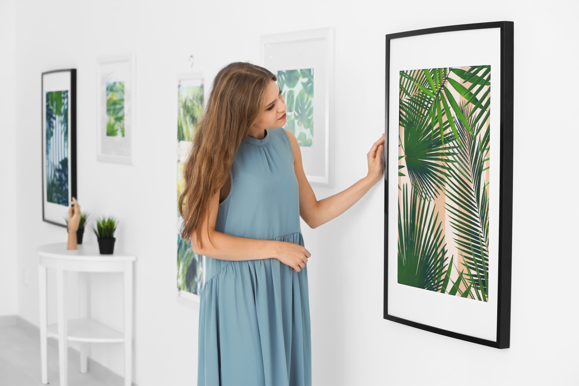 Woman Looking at a Hanged Photo of a Foliage